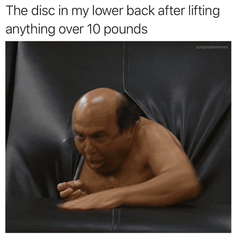 Frank Reynolds naked and sweating while crawling out of a black leather couch, mimicking a herniated disc.