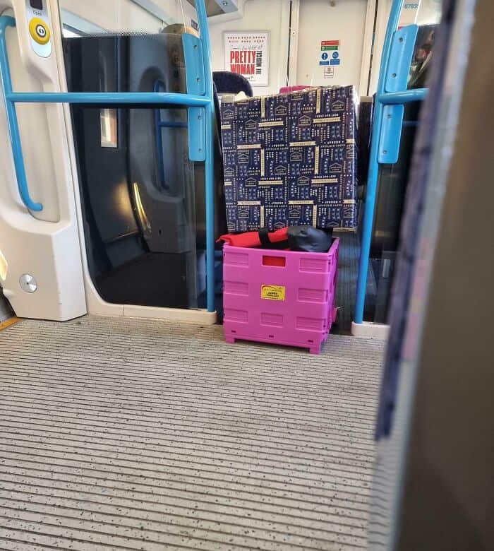 Communal spaces become a frustrating obstacle course when passengers block entire train doors with large crates and designer boxes, perfectly capturing the vibe of annoying people on public transit