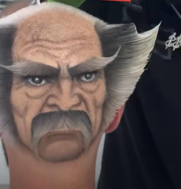 An unbelievable display of barbering skill resulting in a bad haircut, where the back of a man's head has been shaved, dyed, and styled to look exactly like the angry face of a grumpy old man with a mustache.