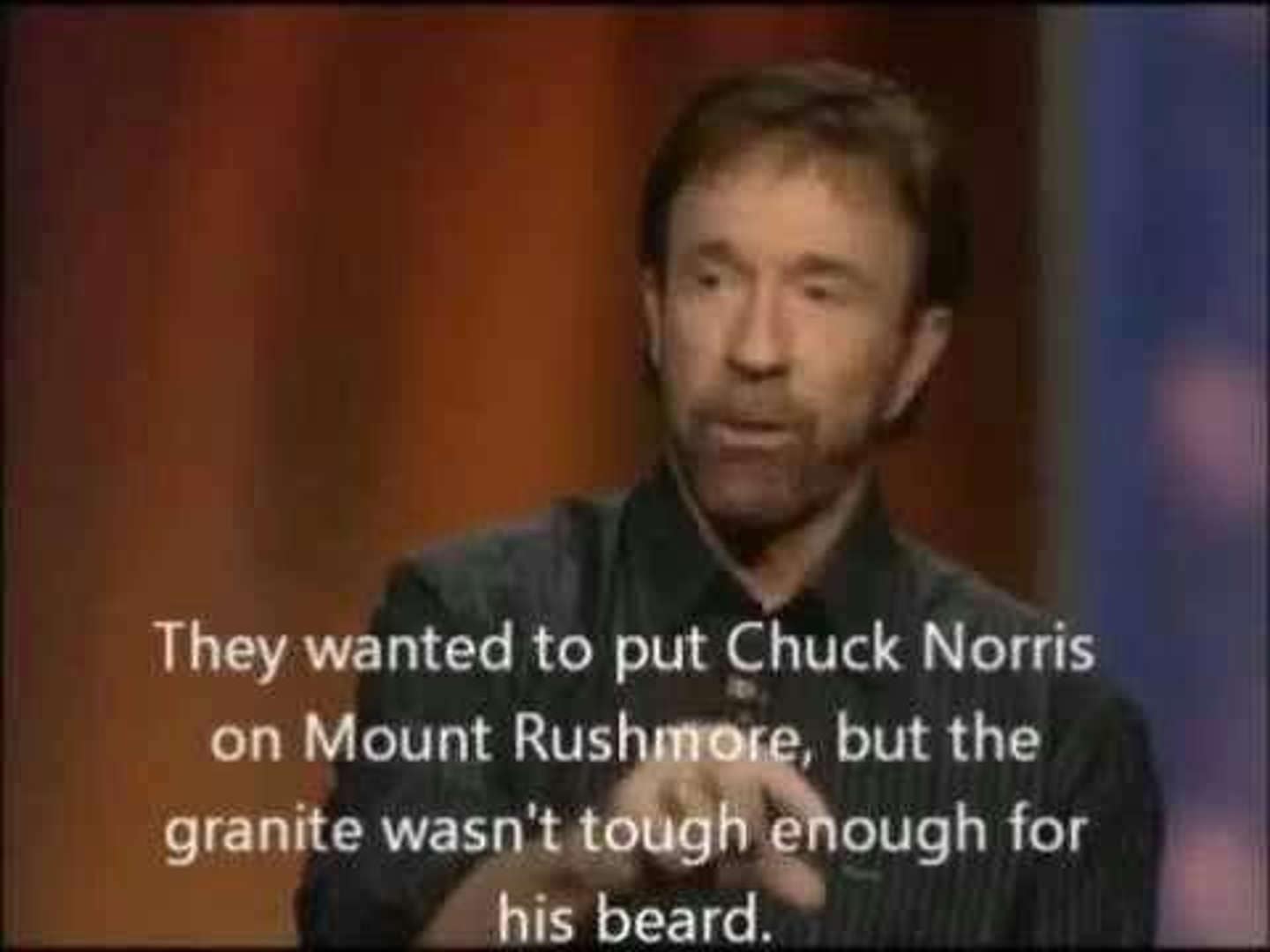 A grainy shot of Chuck Norris making a point during an interview. The caption on this Chuck Norris memes classic explains that he isn't on Mount Rushmore because the granite simply wasn't tough enough to handle a sculpture of his beard.