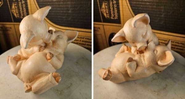A ceramic figurine displayed in a split-frame view, showing two small pigs in a playful—though arguably questionable—wrestling or hugging pose on a marble base.