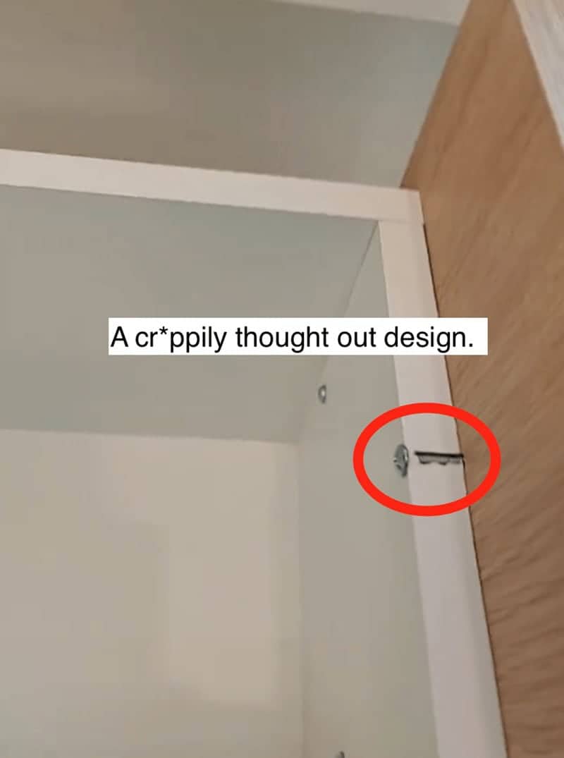 Red circle highlighting a crookedly installed shelf support in a poorly designed modern closet space.