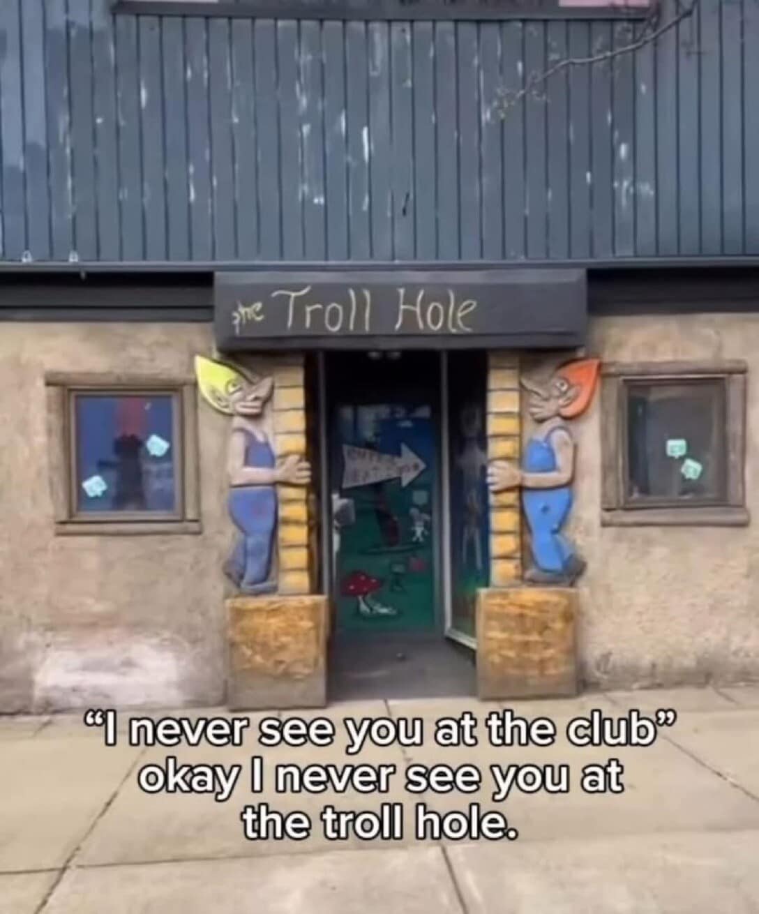 introverted classic meme showing a deeply cursed building called "The Troll Hole," firing back at people who ask why they are never at the club by demanding to know why they are never hanging out at the Troll Hole.