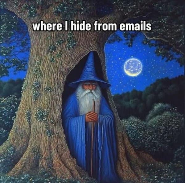 A magical and relatable classic meme using a vintage painting of a bearded wizard hiding deep inside a hollowed-out tree trunk to perfectly represent the desperate urge to escape and hide from incoming work emails.