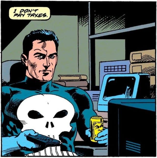 vintage comic book panel featuring The Punisher sitting at a desk with a computer, holding a remote and a yellow can of "Moxie" soda. His expression is stoic as he declares in a speech bubble: "I DON'T PAY TAXES."