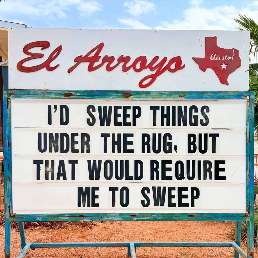 A deeply relatable el arroyo sign confessing I would sweep things under the rug but that would require me to sweep, capturing pure household laziness on a funny restaurant sign.