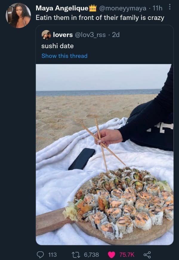 A massive platter of sushi on a beach blanket next to the ocean. Savage food memes joking about eating fish directly in front of their living family.