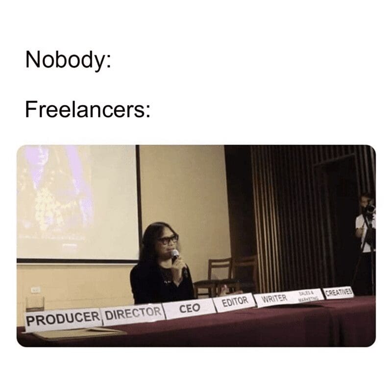 Woman sitting at a table with multiple nameplates including CEO, Editor, Writer, and Producer.