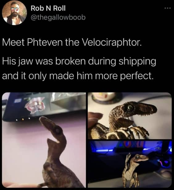 A toy velociraptor with a broken jaw looking like the Phteven internet meme.