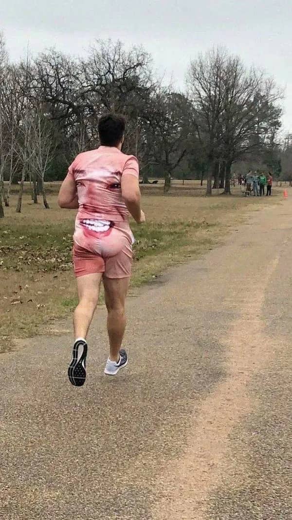 Candid photo of a jogger wearing a shirt and shorts printed with a giant face.