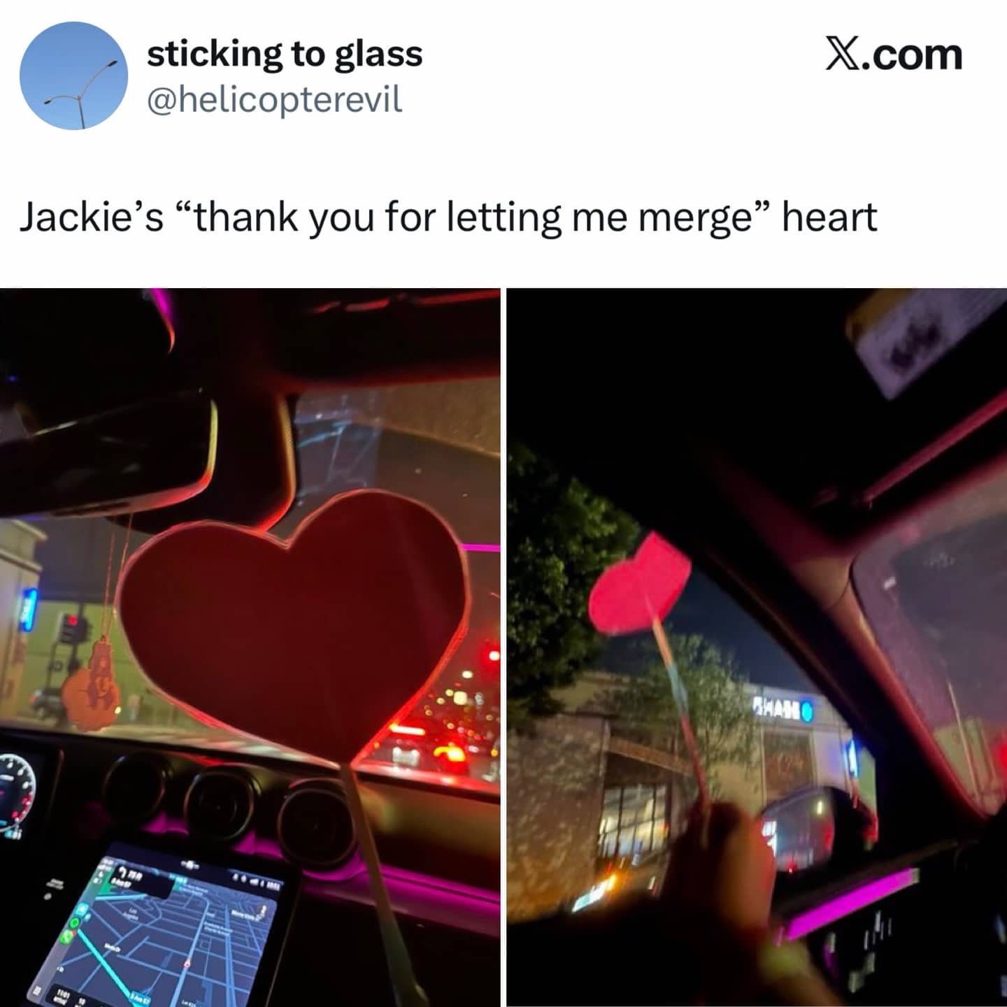 A car interior featuring a large red heart wand used to thank drivers for merging.