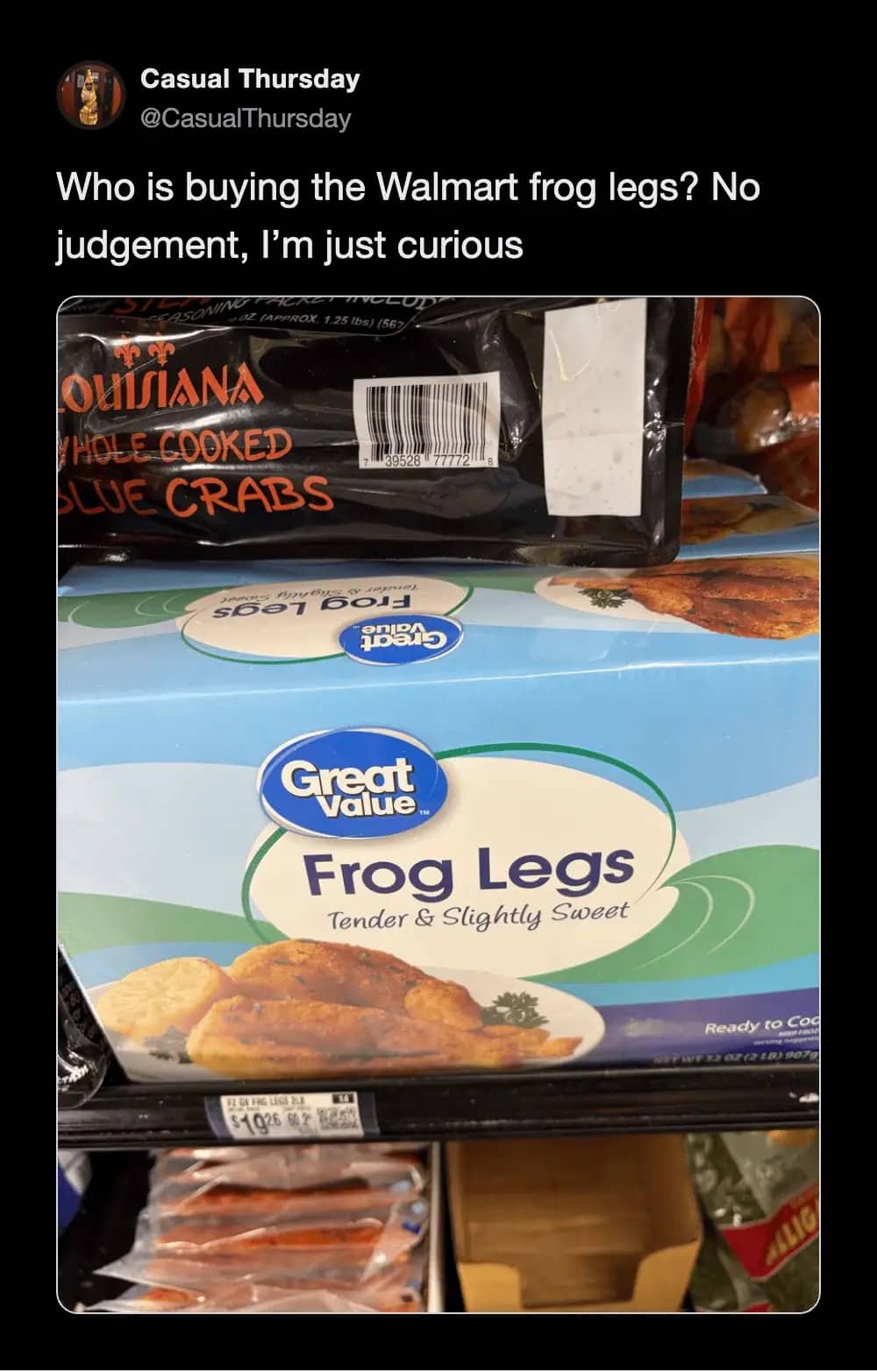 Grocery store freezer shelf stocked with boxes of Great Value frozen frog legs and cooked blue crabs.