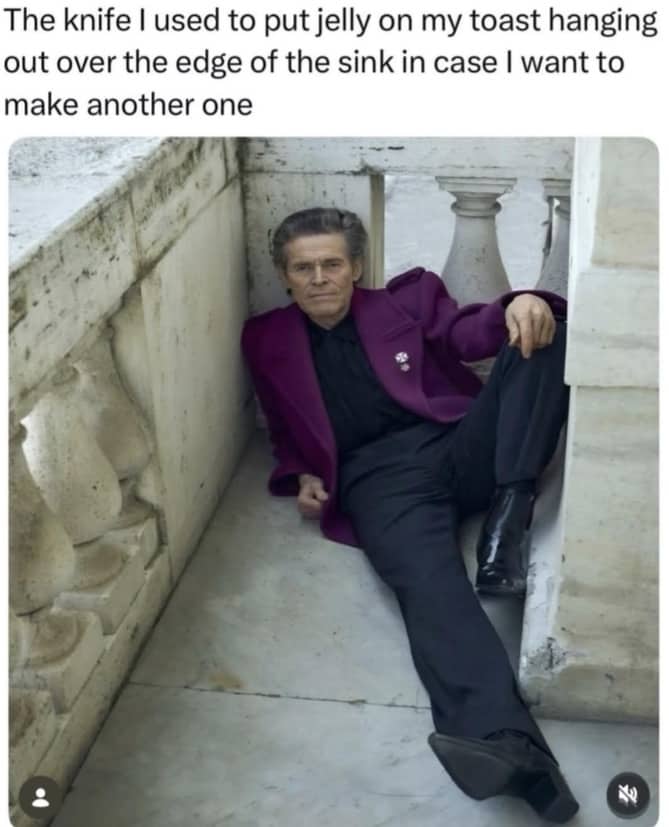 Willem Dafoe reclining against a stone wall, representing a used jelly knife left on the sink.