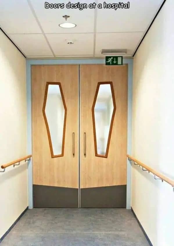 Hospital doors designed with coffin-shaped windows making a funny but dark architectural design fail.
