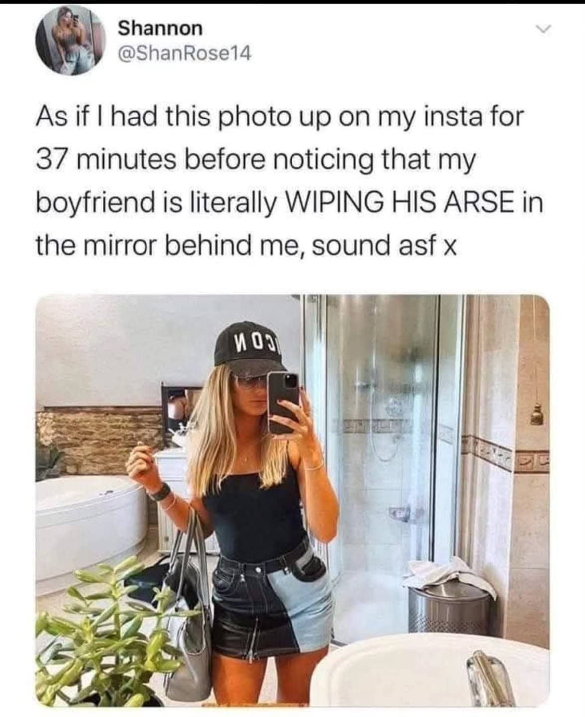 A woman’s bathroom mirror selfie where her boyfriend is accidentally visible in the background wiping himself.