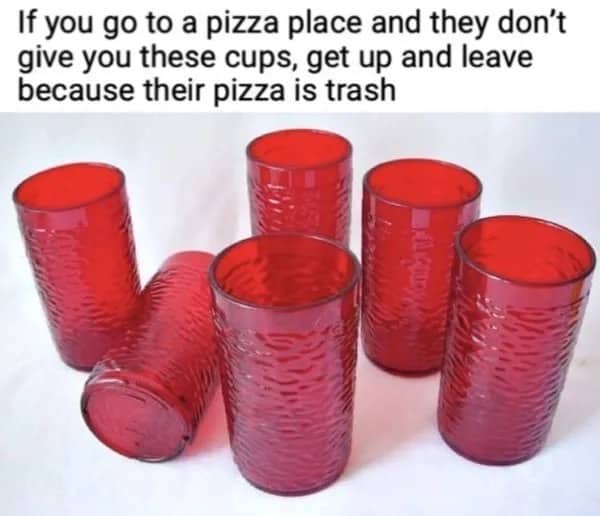 A collection of vintage red pebbled plastic tumblers commonly used in old-school pizza parlors and restaurants.