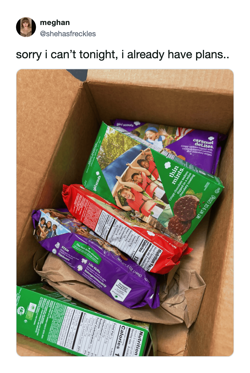 relatable girl scout cookie meme featuring an open cardboard box completely stuffed to the brim with Thin Mints and Caramel deLites, perfectly justifying the excuse to stay home and completely cancel plans for the night.