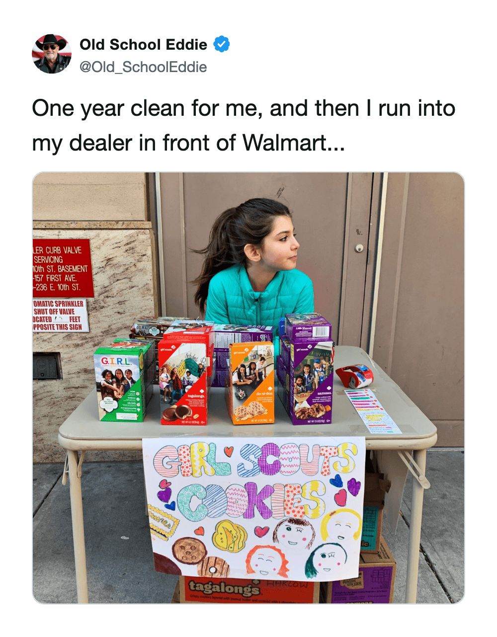 girl scout cookie meme showing a young girl sitting confidently behind a fully stocked table of colorful boxes outside a Walmart, jokingly referred to as a dealer ruining someone's clean streak