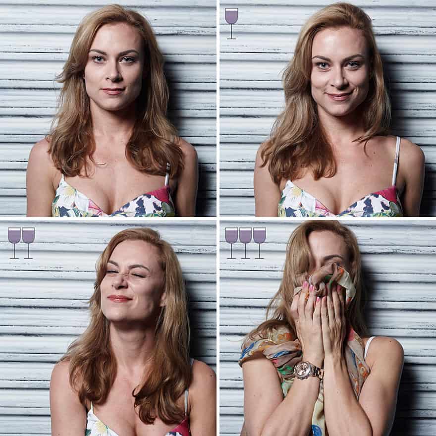 A woman in a floral top hiding her face in a scarf while laughing after wine.