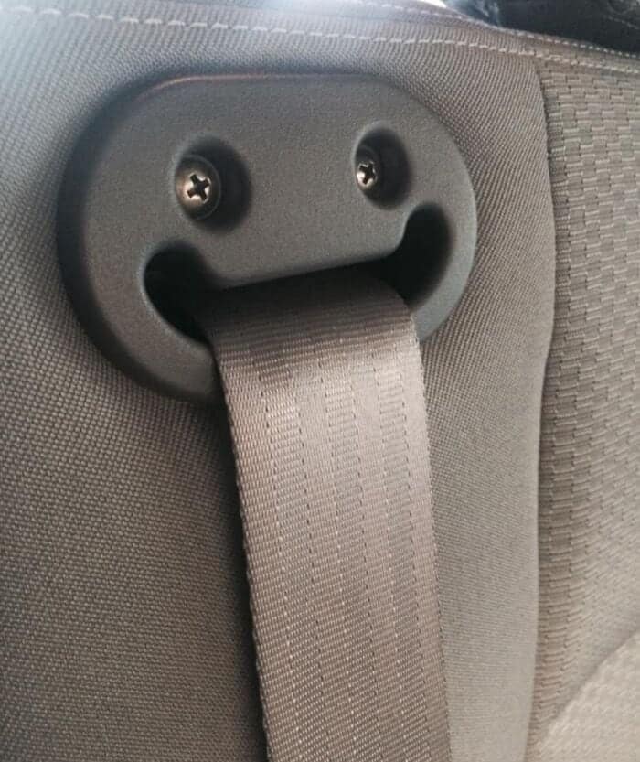 expressive spot of inanimate objects with faces featuring a car seatbelt guide where two metal screws act as eyes above a wide, enthusiastically gaping plastic mouth.