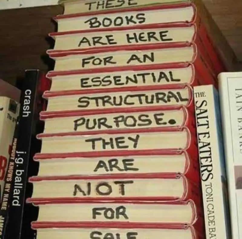 A clever entry in this meme dump showing a stack of books where the spines have been painted to read: "These books are here for an essential structural purpose. They are not for sale."