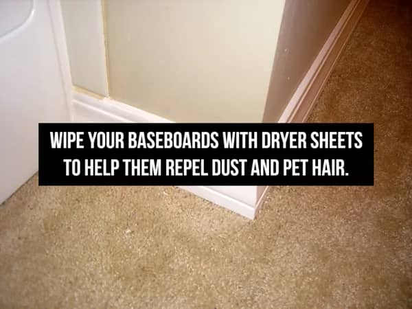 White baseboards against a tan wall with text about using dryer sheets to repel pet hair.
