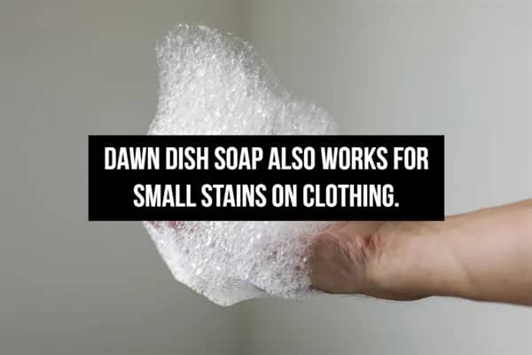 Soapy suds on a hand with text recommending dish soap as an effective spot treatment for clothing.
