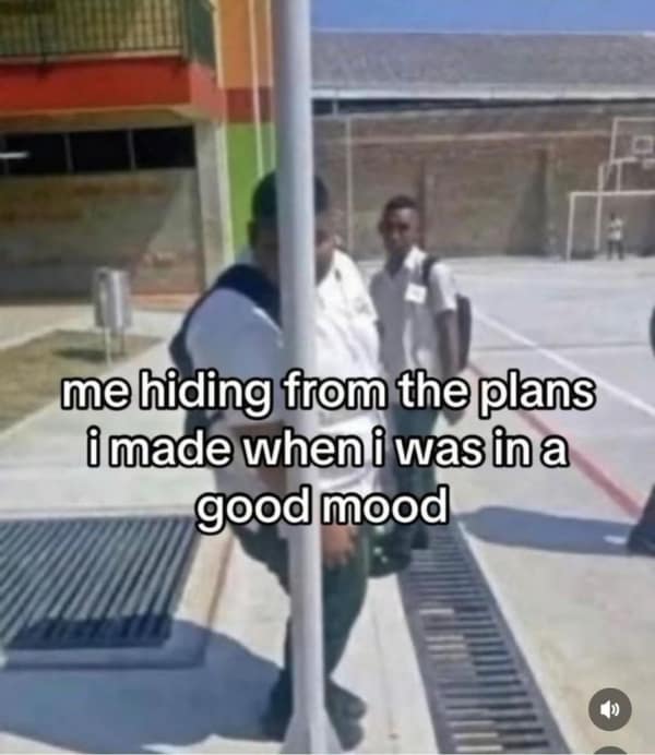 hilarious relatable meme about social regret, showing a blurry photo of a large student attempting to hide behind a very thin flagpole on a playground. The caption reads: "me hiding from the plans i made when i was in a good mood."