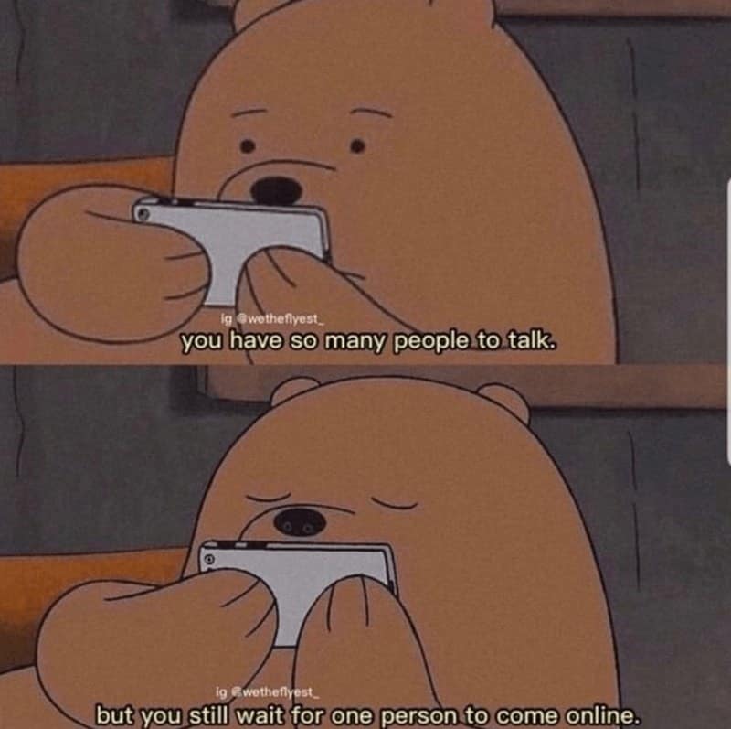 A relatable relationship meme using two panels of Grizzly from We Bare Bears staring intently at his phone. The text describes the specific loneliness of modern romance: "you have so many people to talk. but you still wait for one person to come online."