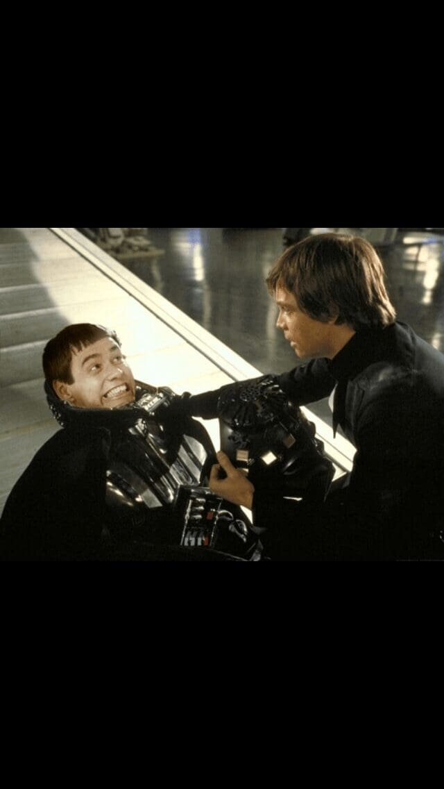 cursed star wars meme showing the emotional scene where Luke Skywalker removes Darth Vader's mask, but underneath is the hilariously derpy, grinning face of the character Simple Jack from the movie Tropic Thunder.