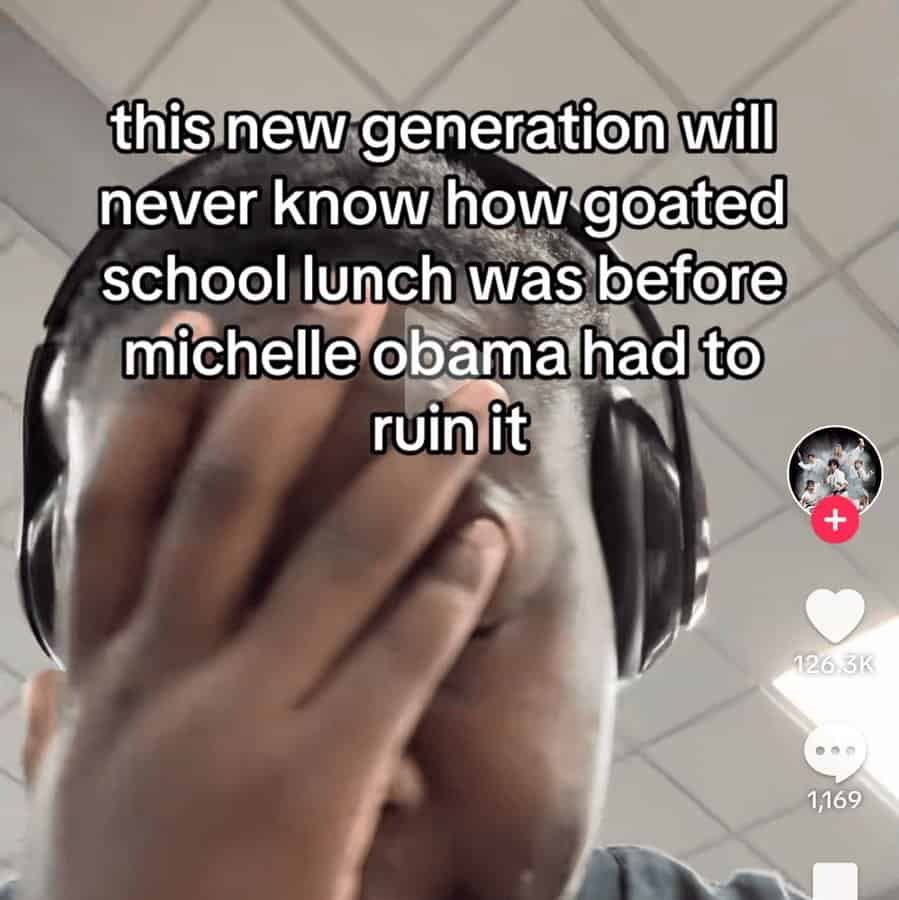 frustrated unhinged screenshot of a man facepalming while wearing headphones. The text laments the loss of "goated" school lunches, blaming Michelle Obama’s healthy eating initiatives for ruining the experience for the "new generation."