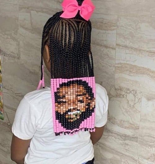 Defying conventional norms at a pool party, a large bearded man in a black polo shirt and athletic shorts stands confidently in a pair of white, open-toe platform high-heeled sandals