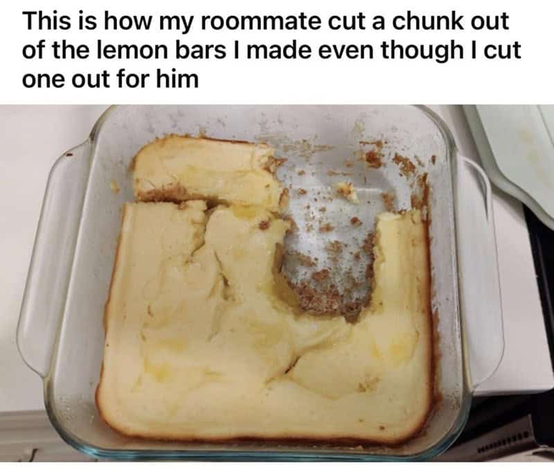 chaotic food crime committed by one of the worst roommates. A glass pan of lemon bars shows a massive, irregular square hacked out of the center-right, completely ignoring the clean, pre-cut lines provided by the baker.