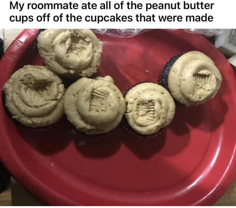 frustrating worst roommates snack-related crime. A red plastic plate holds four chocolate cupcakes with peanut butter frosting. In a display of extreme selfishness, someone has picked off and eaten the Reese's peanut butter cup topper from every single cupcake.