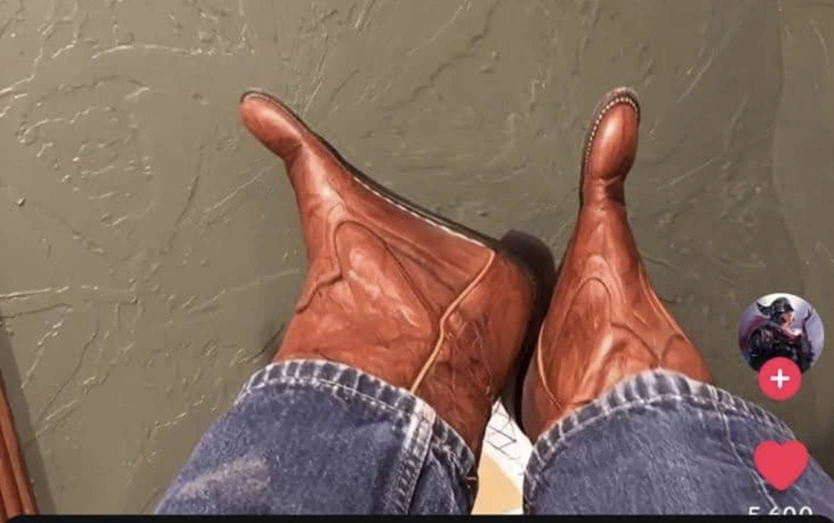 Person wearing unique leather boots designed to look like bare human feet with realistic toes.