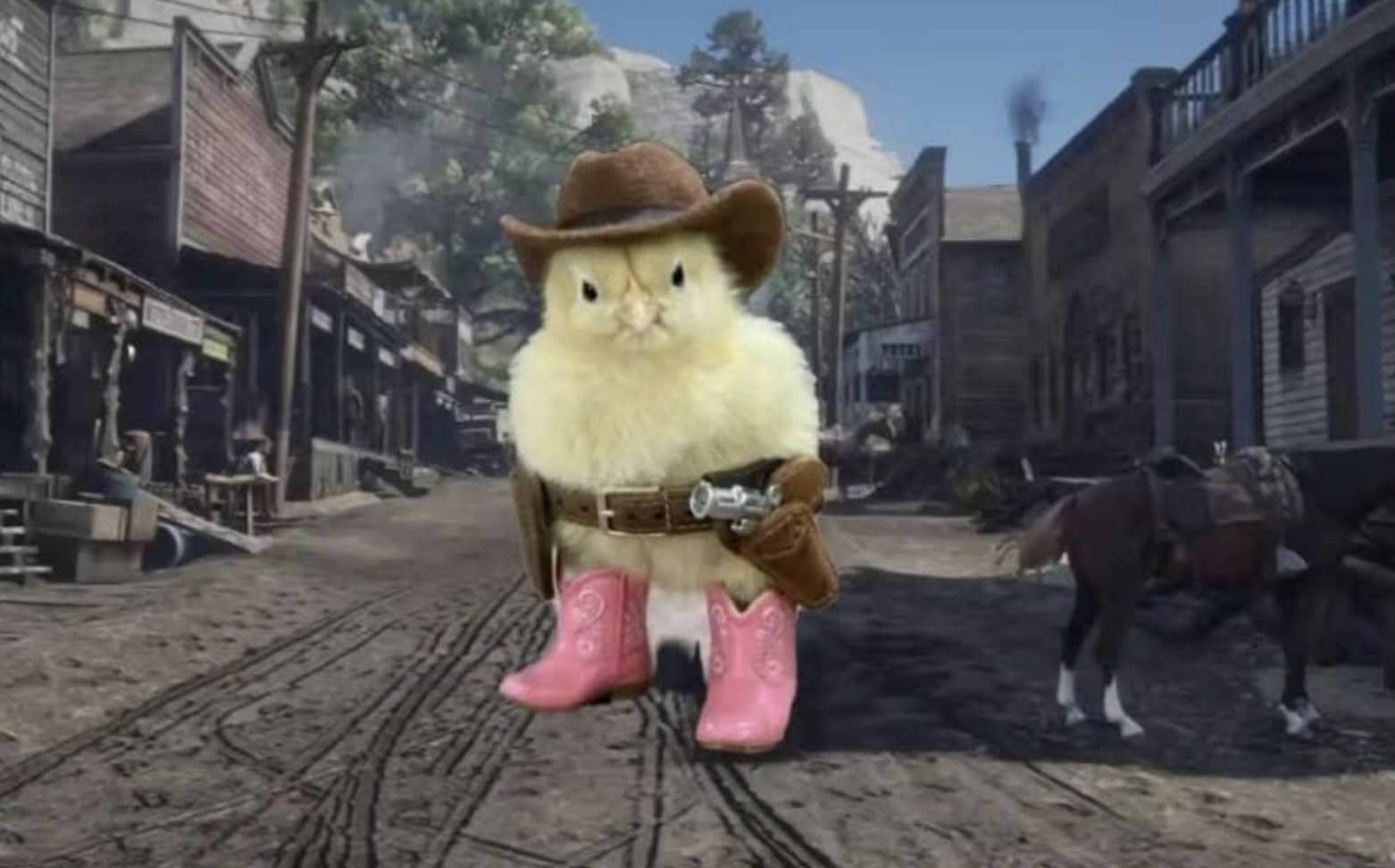 Small yellow chick wearing a cowboy hat, pink boots, and a gun belt in the desert.