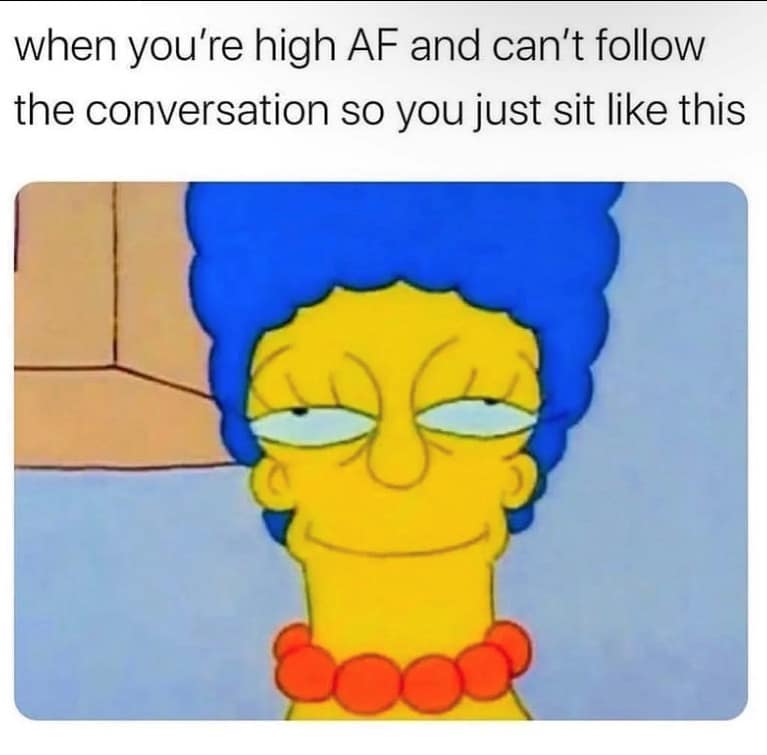 Marge Simpson stares blankly with heavily lidded, glassy eyes and a faint, frozen smile in this 420 meme about social overload. It perfectly illustrates the experience of being so high that you can no longer follow the plot of a conversation and have committed to just "existing" in the room.