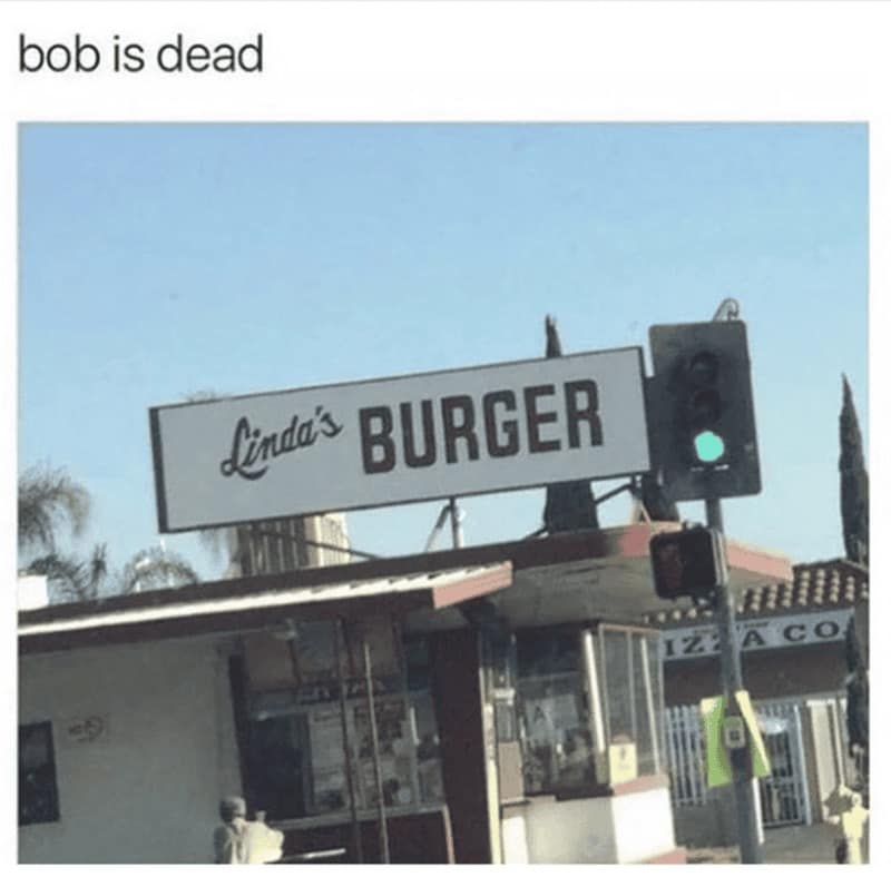 gritty real-world photo of a restaurant sign provides the base for this Bob's Burgers meme titled "Bob is dead." The sign reads Linda's BURGER, humorously implying a dark alternate timeline where Linda has taken over the business following Bob's untimely departure.