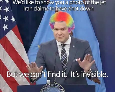 A mock Pentagon briefing Pete Hegseth meme. Hegseth is photoshopped at a podium wearing a bright rainbow clown wig. The text parodies military rhetoric about an "invisible" jet that Iran claims to have shot down but can't be found.