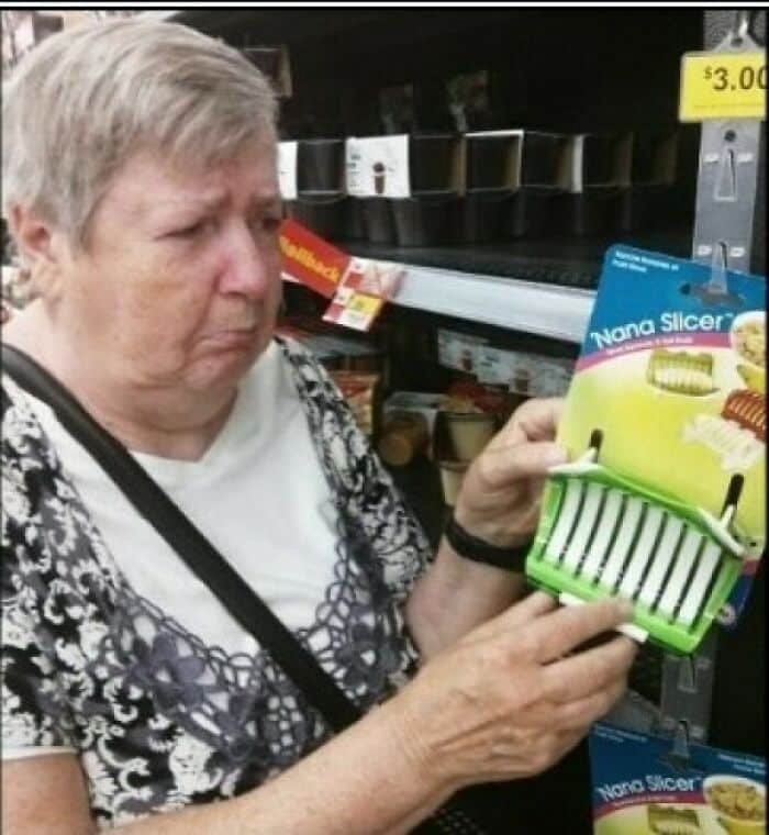 Woman squinting confused at kitchen gadget called "Nana Slicer" appearing to be appalled at product.