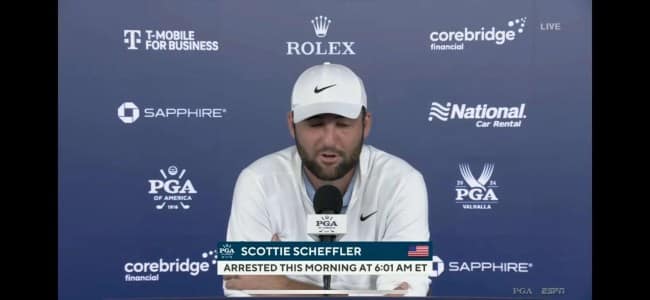 A broadcast still from ESPN showing golfer Scottie Scheffler at a press conference. The lower-third graphic starkly reports: "ARRESTED THIS MORNING AT 6:01 AM ET," providing a jarring contrast to the Rolex and T-Mobile sponsor logos behind him.