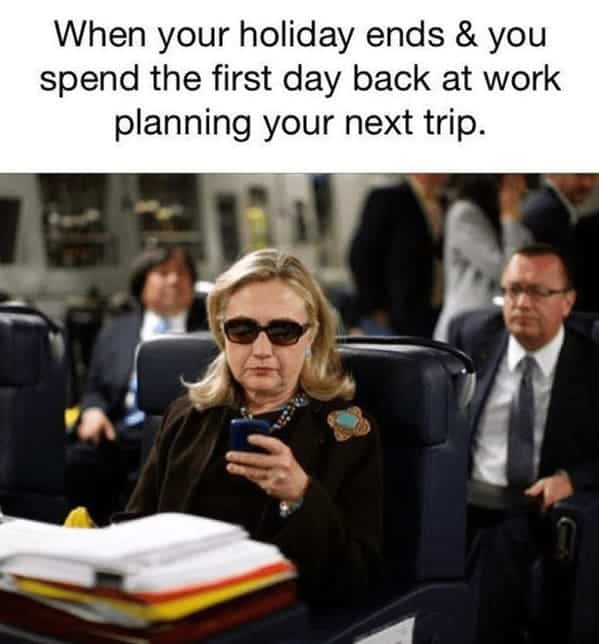 This relatable airplane meme features Hillary Clinton sitting in a plane seat wearing dark sunglasses and intensely focused on her phone. The text describes the "vicious cycle" of returning to work only to immediately start planning the next vacation.