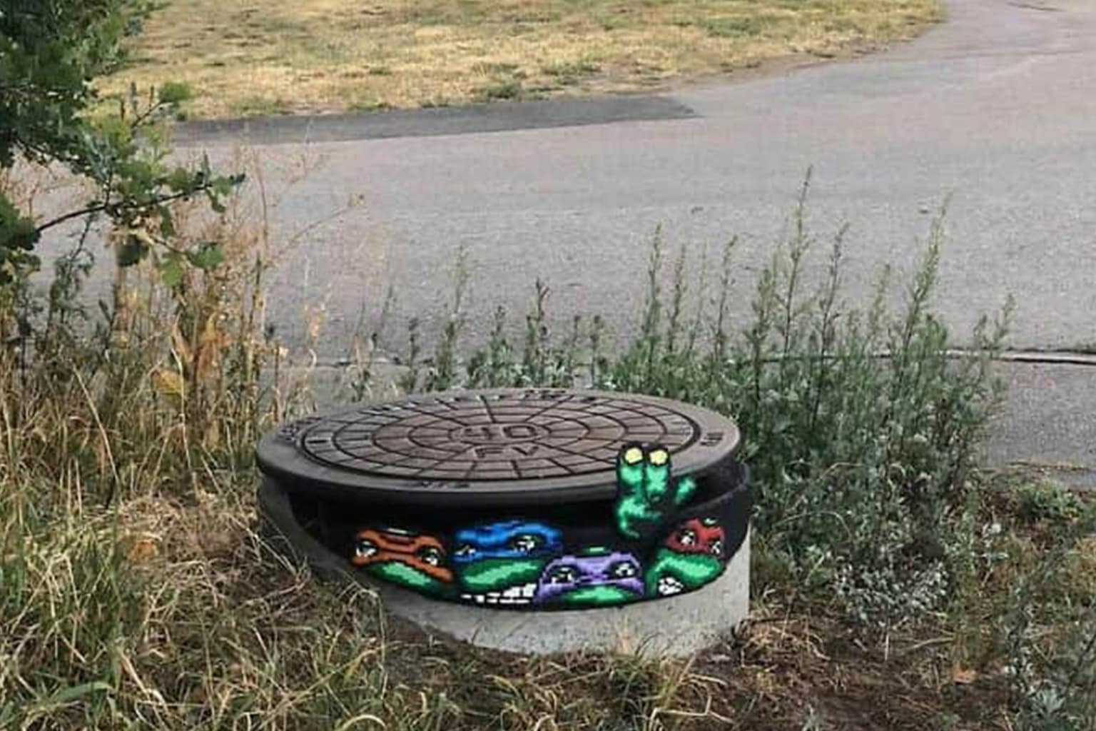 An amazing street art mural dump that includes a mural of a girl whose "hair" is a real blooming purple bougainvillea bush, a hyper-realistic chrome astronaut that reflects the city skyline, and a 3D shark appearing to shatter a glass tank with a painted tennis ball.