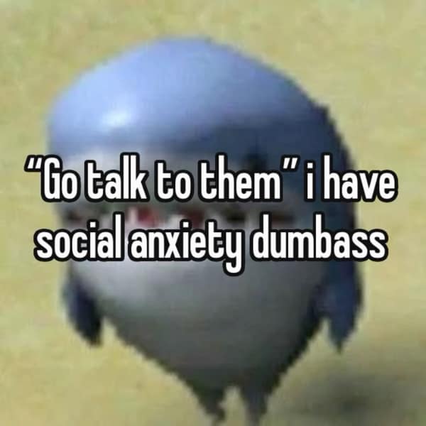 A hilarious anxiety meme featuring a low-resolution, wide-eyed blue shark toy looking startled. The text overlay reads: "'Go talk to them' i have social anxiety dumbass," poking fun at the uselessness of simple social advice for someone in a spiral.