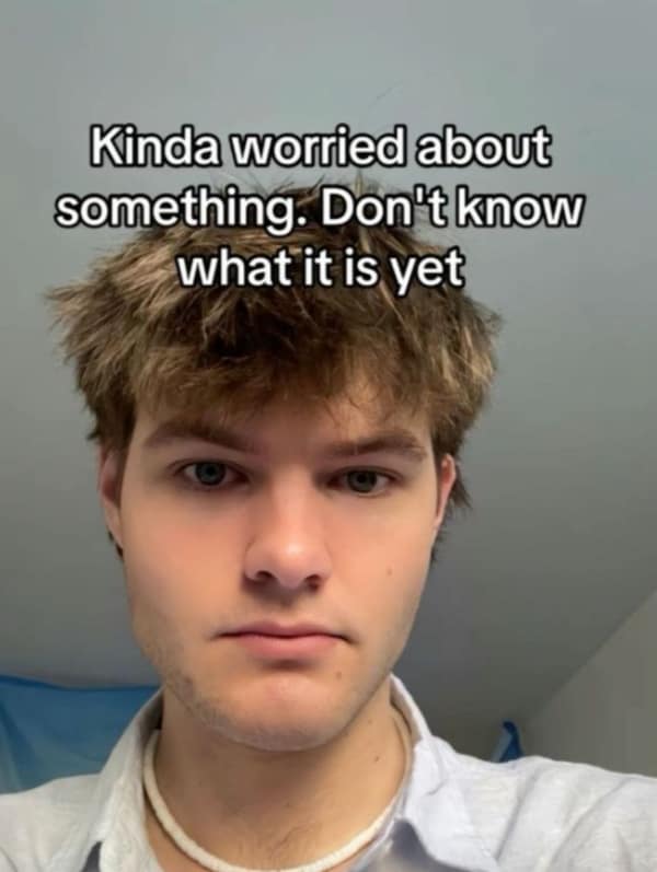 A relatable anxiety meme showing a young man looking directly into the camera with a confused, flat expression. The caption reads: "Kinda worried about something. Don't know what it is yet," perfectly capturing the feeling of free-floating dread.