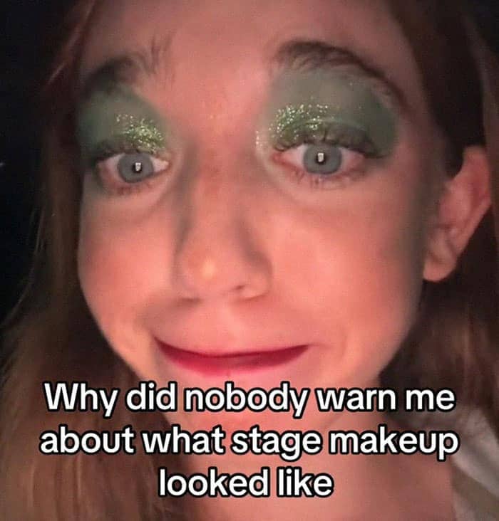 Close-up of performer with heavy green glitter eye shadow captioned "why did nobody warn me about stage makeup"