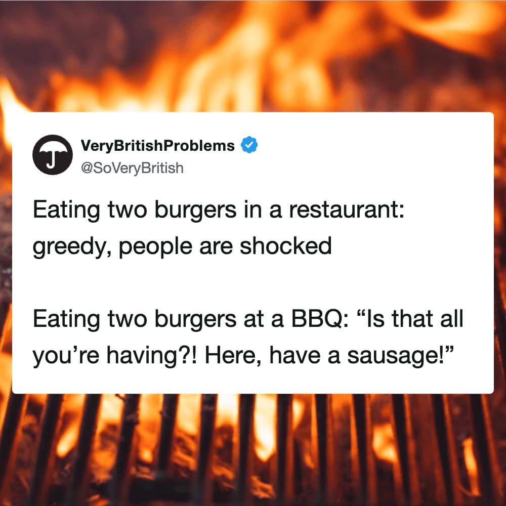 A cultural bbq meme tweet from VeryBritishProblems highlighting the hypocrisy of social eating. It notes that eating two burgers at a restaurant is seen as "greedy," while eating two burgers at a BBQ is met with "Is that all? Here, have a sausage!"