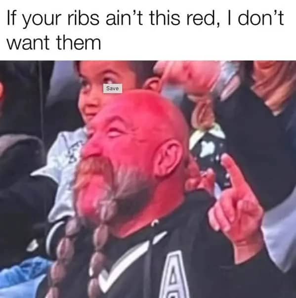 A very red-faced man at a game representing the ideal color of BBQ ribs.