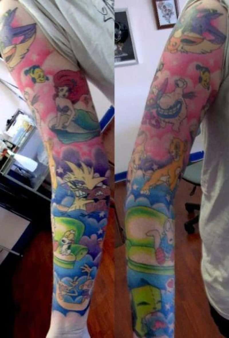 Full cartoon sleeve tattoo featuring Little Mermaid Lion King and classic 90s animated characters