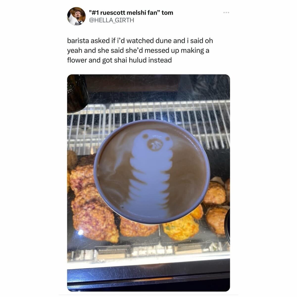 A high-octane classic meme for sci-fi fans. It shows a cup of coffee with accidental latte art that looks exactly like the Shai-Hulud sandworm from Dune, complete with a circular, toothy maw. The caption explains the barista tried to make a flower but summoned a desert god instead.